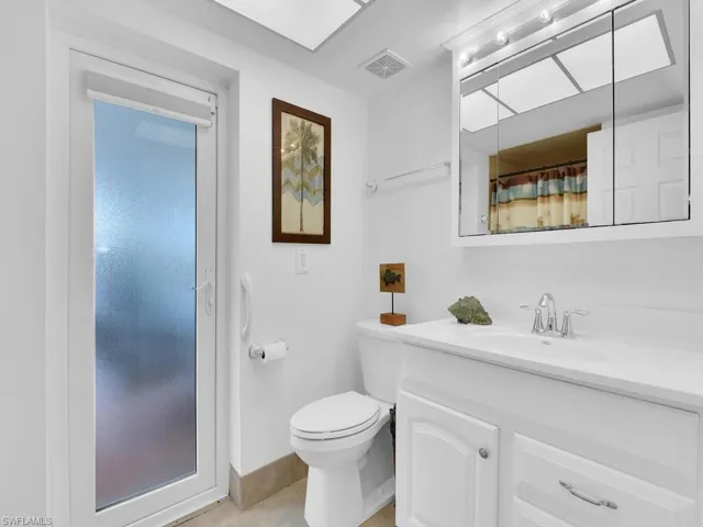 Bathroom with tile patterned floors, vanity, and toilet