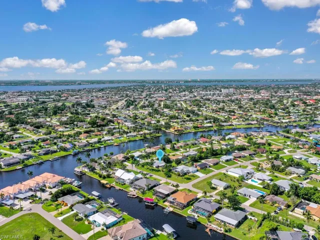 Birds eye view of property with a water view