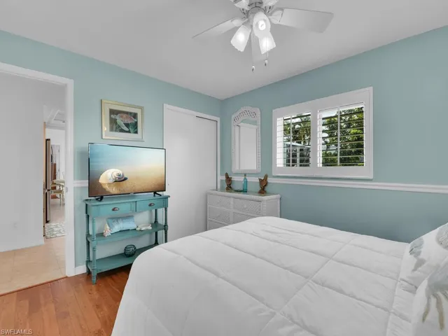 Bedroom with a closet, ceiling fan, and hardwood / wood-style floors