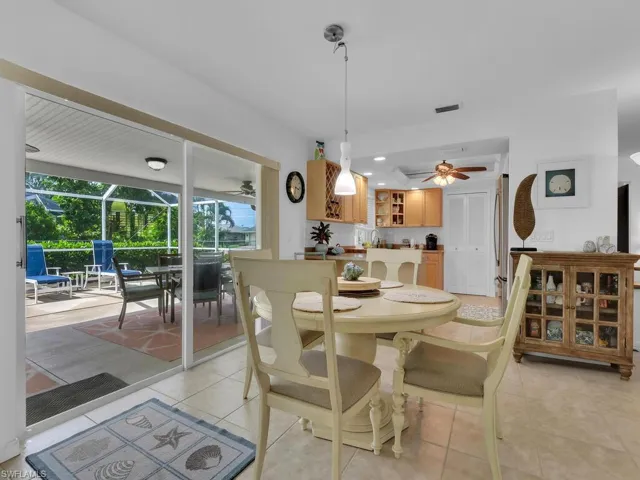 Dining space featuring light tile patterned floors and ceiling fan