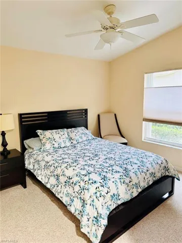 Bedroom with light colored carpet and ceiling fan