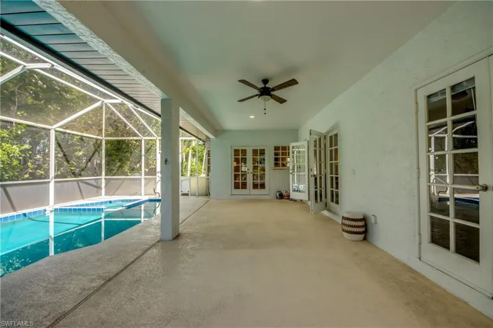 French doors lead to the kitchen at the far end of the lanai