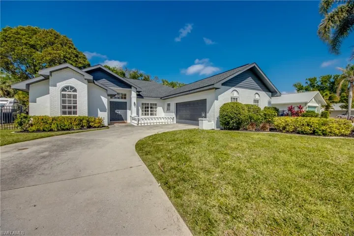Front of the home with a side loading 2 car garage