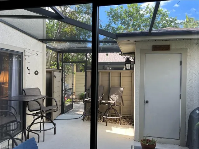 View of fenced lanai and storage building