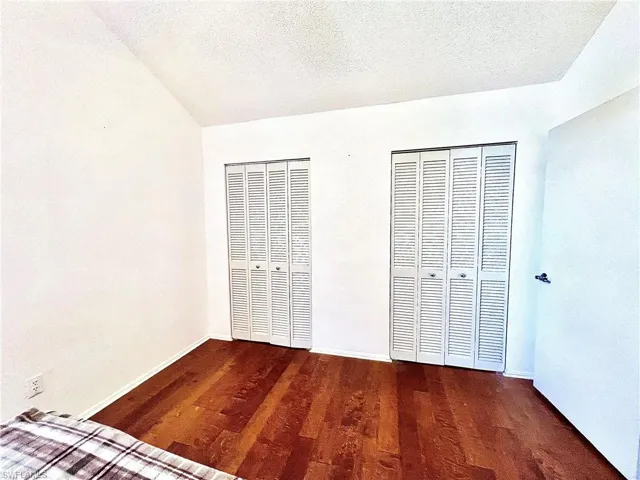 2nd floor bedroom with multiple closets and hardwood flooring