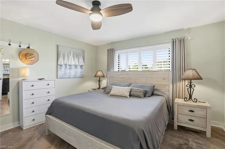 Bedroom featuring wood finished floors and a ceiling fan - Expanded closet