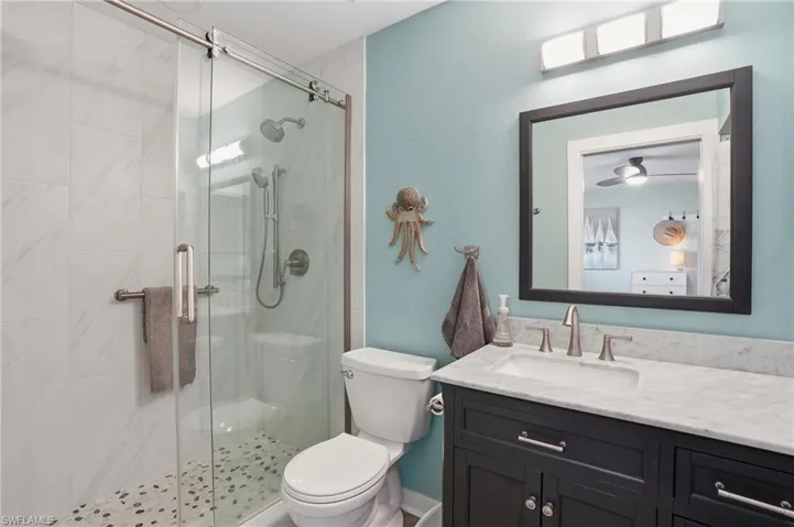 Private bath with vanity and a stall shower