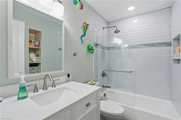 Secondary full bathroom featuring shower / bathtub combination and vanity.