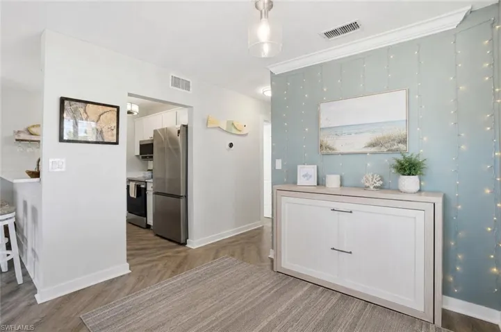 VIRTUALLY STAGED Remove the table, add a murphy bed credenza for more living