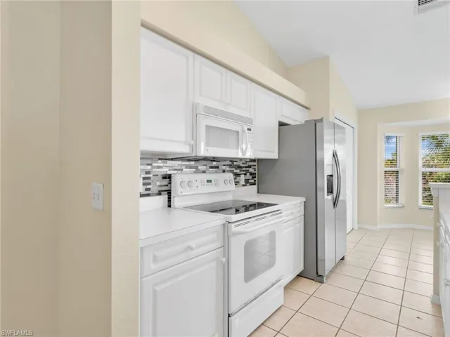 Kitchen with Stainless Steel Refrigerator & Tile Backsplash