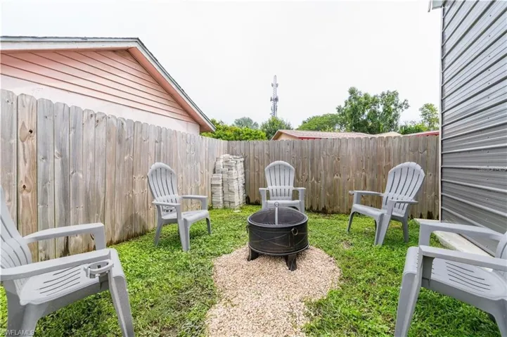 Fenced backyard with a fire pit