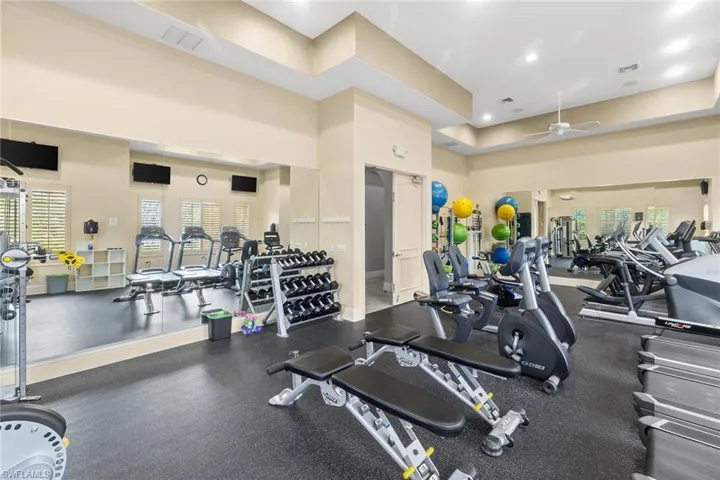 Workout area with a high ceiling, a ceiling fan, and recessed lighting