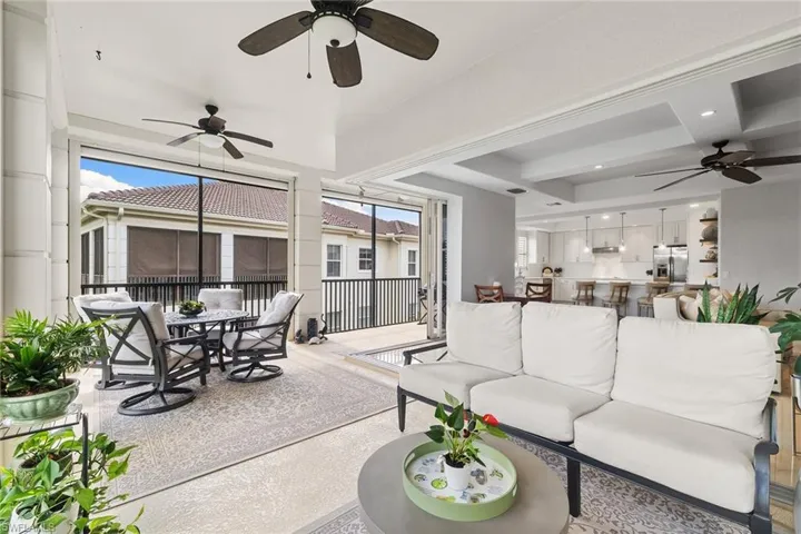 Living area featuring ceiling fan and speckled floor