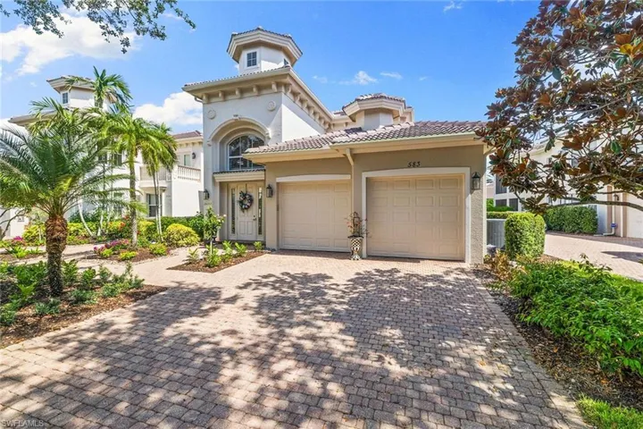 Mediterranean / spanish-style house featuring decorative driveway, stucco siding, an attached garage, and a tiled roof
