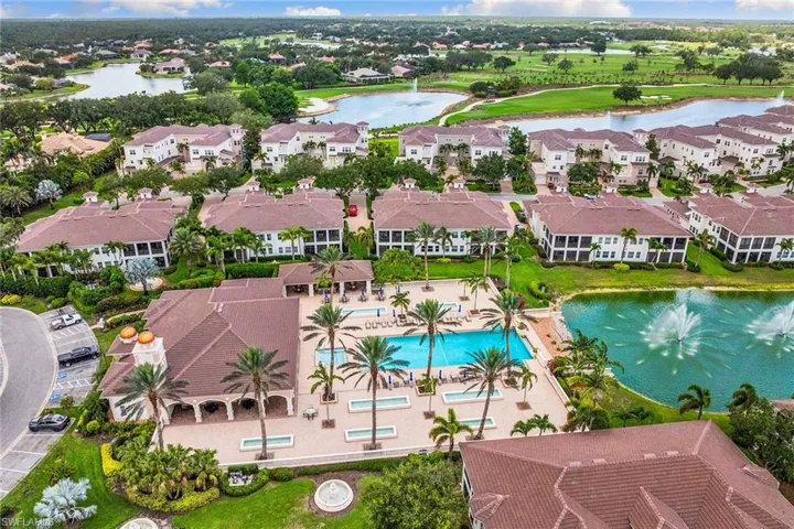 Aerial view of property and surrounding area with a large body of water and nearby suburban area