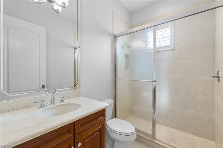 Full bathroom with vanity and a stall shower
