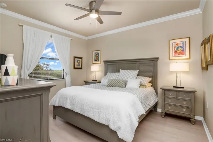 Primary bedroom with upgraded light fixture and LVP flooring