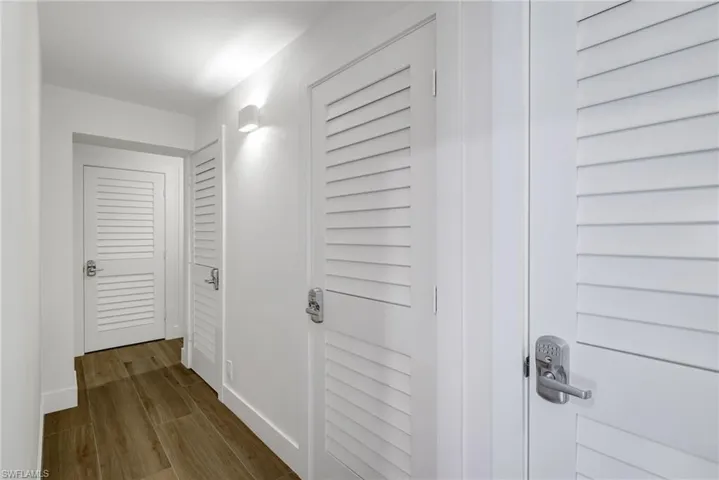Corridor with wood tiled floors and baseboards