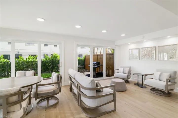 Living room with light wood finished floors and recessed lighting