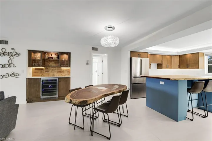 Dining area featuring beverage cooler and a chandelier