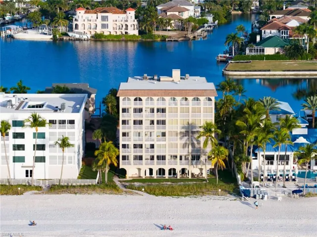 Drone / aerial view of a large body of water and apartment complex