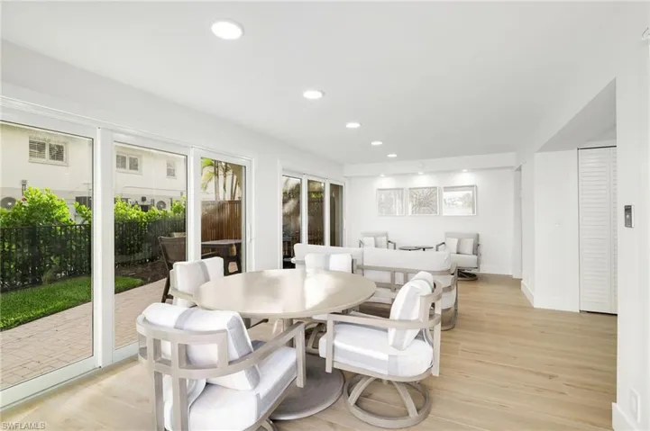 Dining area with light wood-style floors and recessed lighting