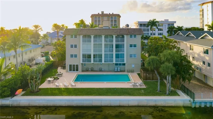 Back of house with a patio area, a fenced backyard, stucco siding, and a community pool