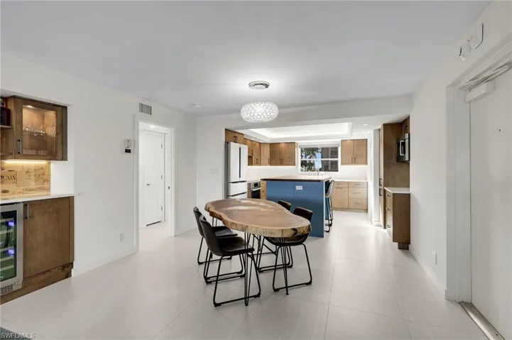 Dining space featuring beverage cooler and baseboards