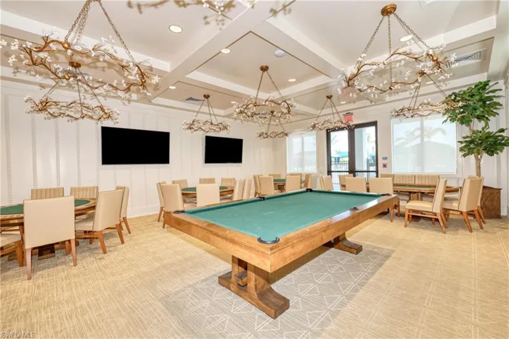Recreation room with beamed ceiling, a chandelier, and coffered ceiling