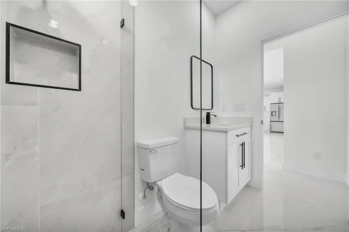 Full bathroom with vanity and light marble finish flooring