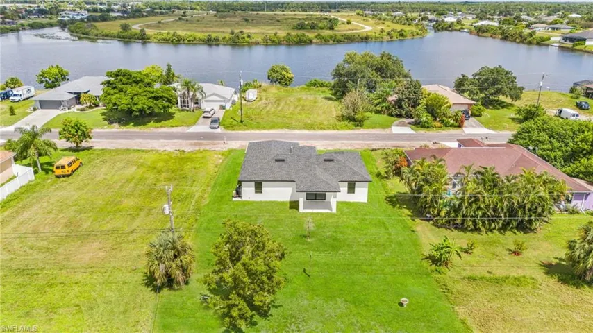 Aerial view of residential area featuring a large body of water