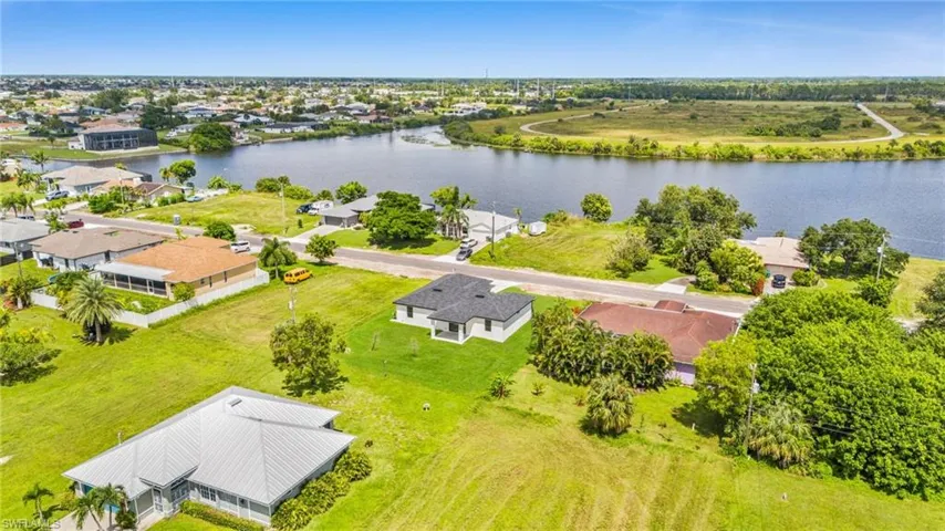 Aerial perspective of suburban area with a nearby body of water