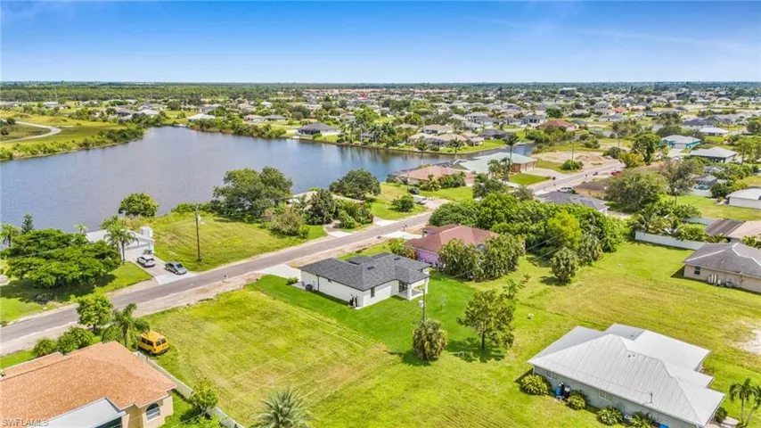 Aerial perspective of suburban area with a nearby body of water