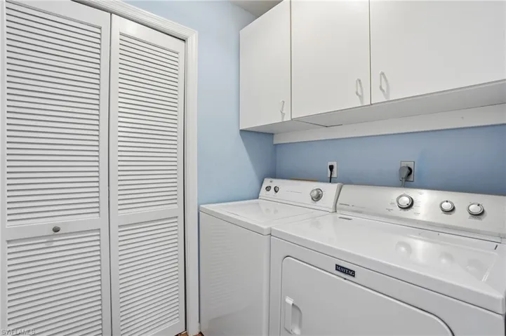 Washroom with washer and dryer and cabinet space