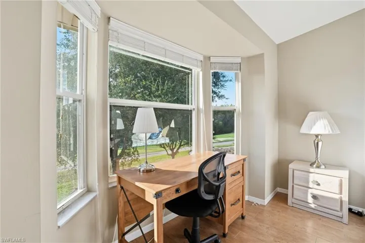 Office area with healthy amount of natural light and light wood-style floors