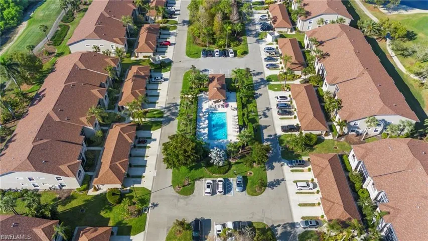 Aerial view of property and surrounding area featuring nearby suburban area