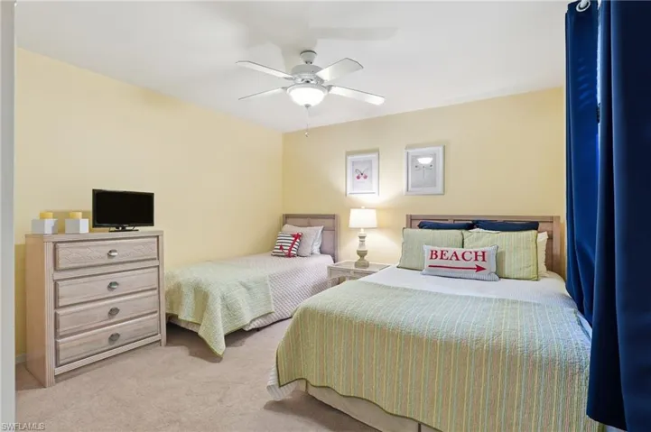 Bedroom featuring light colored carpet and ceiling fan