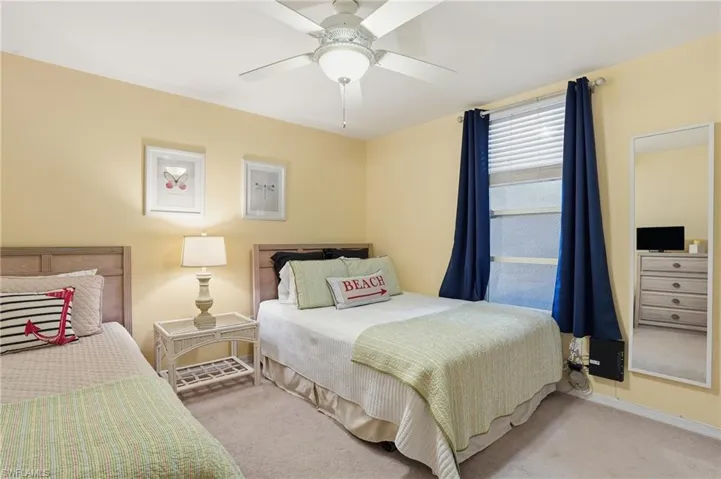 Bedroom featuring ceiling fan and carpet
