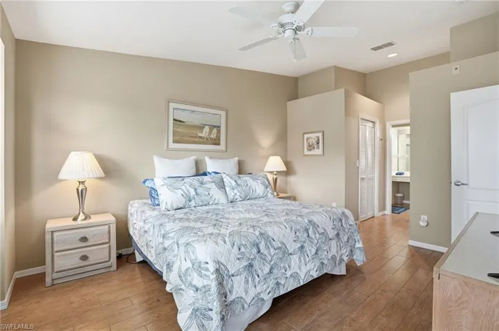 Bedroom with a closet, hardwood / wood-style floors, and ceiling fan