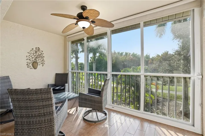 Sunroom with view of scattered trees