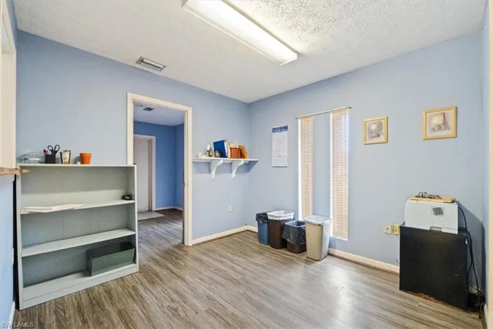 Miscellaneous room featuring light wood-style floors and a textured ceiling