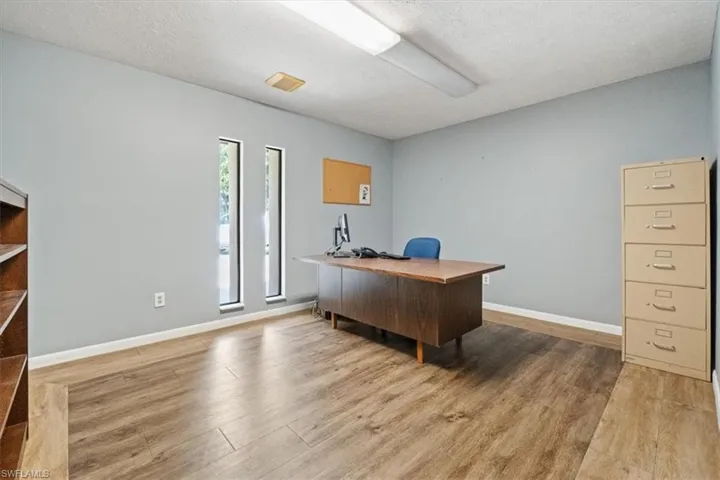 Office featuring a textured ceiling and light wood finished floors