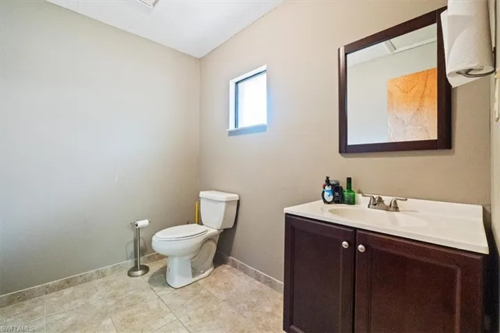 Half bathroom with vanity and toilet