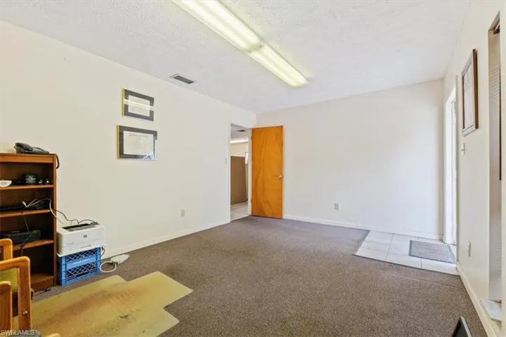 Unfurnished bedroom with carpet flooring and a textured ceiling