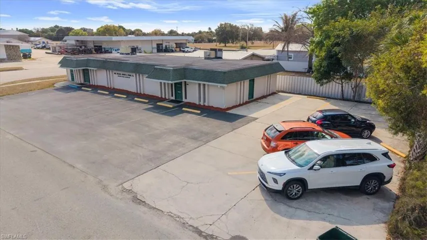 View of building exterior featuring uncovered parking