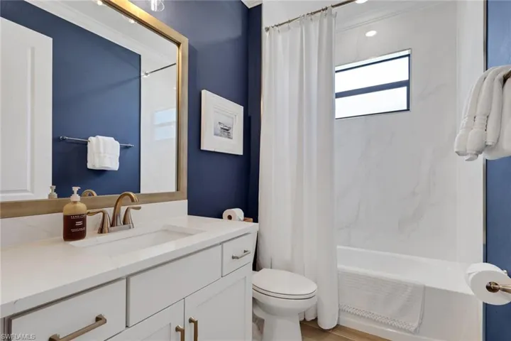 Full bath featuring shower / bath combo with shower curtain and vanity