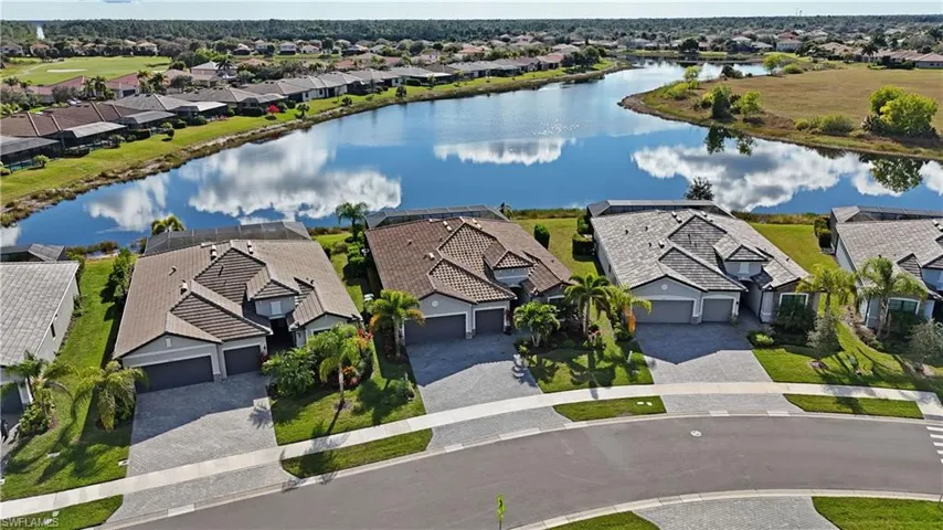 Aerial view of residential area featuring a nearby body of water