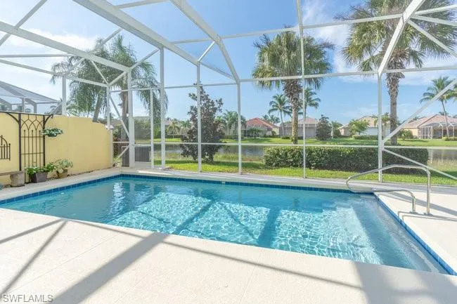 View of pool featuring a water view, a patio, and a lanai