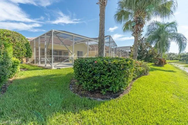 View of yard featuring glass enclosure