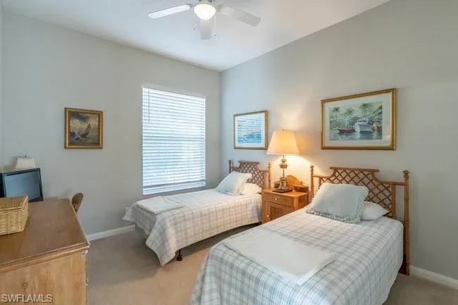 Carpeted bedroom with ceiling fan